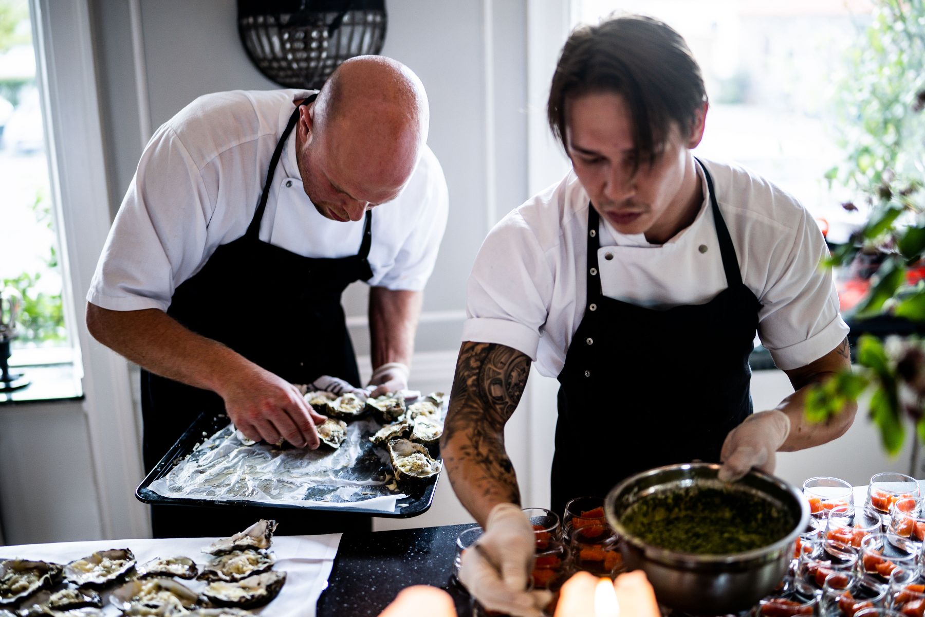 Chefs plating in a professional kitchen environment